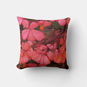 Almohada con flores rojas pequeñas y un dicho amis