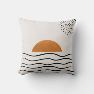 Almohada con olas del océano y puesta de sol dorad