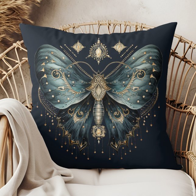 Almohada de lanzamiento de bruja de polilla azul c (Celestial Blue Moth Witchmas Throw Pillow in a boho rattan armchair.)