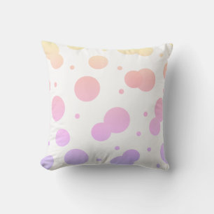 Almohada de lunares suaves en amarillo, rosa y lav