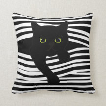 Almohada de rayas con gato asomándose