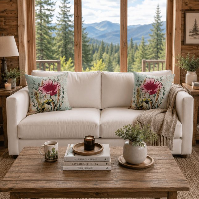 Almohada decorativa botánica de flores silvestres (White sofa with matching wildflower botanical throw pillows in a bright contemporary cabin.)