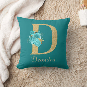 Almohada decorativa de letra floral dorada y acuát