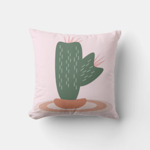 Almohada decorativa rosa con cactus espinoso sobre