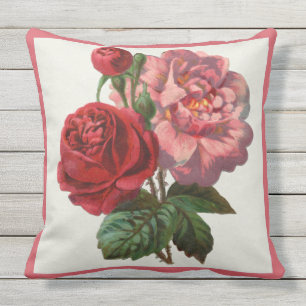 Almohada del patio rosada y rosas rojos florales
