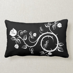Almohada negra con diseño del rosa blanco