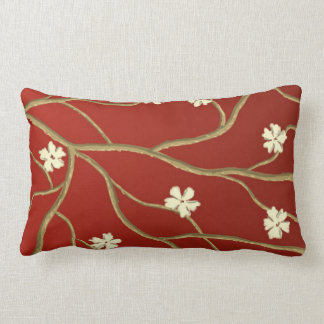 Almohada roja del acento con las ramas