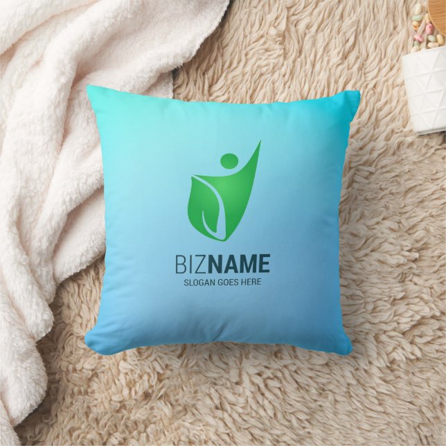 Almohada turquesa con un logotipo de figura abstra (Manta)