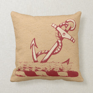 Ancla roja en una almohada nudosa del fondo del