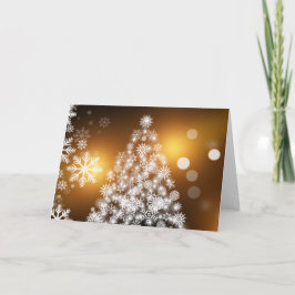 Árbol de Navidad con copo de nieve con fondo dorad