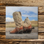Azulejo De Cerámica Botas y mosaico de puros<br><div class="desc">Un impresionante cielo de Wyoming es el telón de fondo de esta fotografía de botas occidentales gastadas con auténticas espuelas de plata hechas por personalizados,  con pesos mexicanos de los años 1880 para las cuerdas. ¡Una idea de regalo perfecta para el vaquero,  vaquero o cualquiera que ame a Occidente!</div>