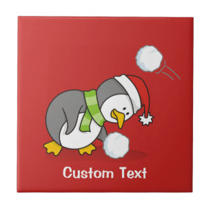 Azulejo De Cerámica Pingüino navidad recibiendo bola de nieve