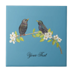 Azulejo Dos estorninos en una rama floreciente en primaver