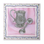 Azulejo Heirloom Cup y Rattle con fondo morado<br><div class="desc">Una taza de herencia se sienta al lado de un bebé rattle en este trabajo de Tara Friel. Una figura de un oso de peluche está tallada en el extremo del ganado,  y intrincados motivos florales adornan los lados del vaso. ¡Una gran pieza,  pon esto en tu pared hoy!</div>