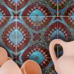 Azulejo Pétalos geométricos simétricos de color rojo borgo<br><div class="desc">Esta cerámica es una pieza de arte cautivadora, con un diseño intrincado y simétrico que recuerda a flores florecientes o imágenes caleidoscópicas. El diseño está dominado por formas que se asemejan a pétalos, representadas en ricos tonos burdeos y rojo intenso. Estas formas se delinean con líneas delicadas, añadiendo definición y...</div>