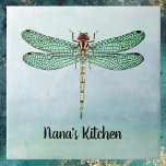 Azulejo Vintage Green Gold Dragonfly sobre las aguas azule<br><div class="desc">Este diseño presenta un ilustracion de libélula vintage verde, oxidado y dorado con un suave fondo de color azul-verde. El patrón verde y negro en las alas de la libélula es luminoso y distintivo. Su nombre u otro mensaje que desee, como "Nana's Kitchen" o "Be Kind", aparece debajo de una...</div>
