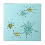 Baldosa cerámica atómica azul de Starbursts del<br><div class="desc">El modelo atómico icónico azul de la baldosa cerámica de Starbursts del huevo de este petirrojo ofrece starbursts atómicos icónicos. ¡Eso correcto! La escuela vieja, fondo coloreado azul del huevo del petirrojo con los puntos del oro es el contexto perfecto para la turquesa vibrante, el apio calmante, y los círculos...</div>