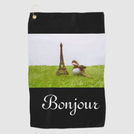 Balón de golf con toalla Eiffel sobre bonjour verd