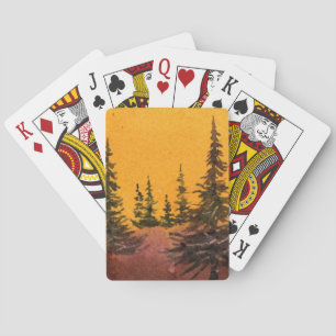Baraja De Cartas Pinos en una colina con un suave amanecer naranja