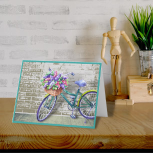 Bicicleta con tarjeta de nota de cesta de flores