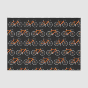 Bicicleta naranja sobre papel de tejidos negros