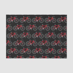 Bicicleta roja sobre papel de tejidos negros