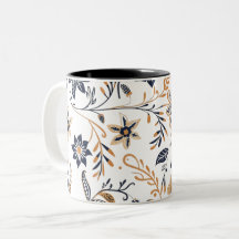 Taza con elegante patrón floral azul y dorado