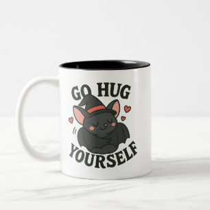Bicolor Taza de murciélago 'Vete a abrazarte a ti mismo' –