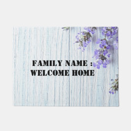 Bienvenido a casa fuera de la alfombra de la puert