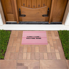 Bienvenido a casa fuera de la alfombra de la puert