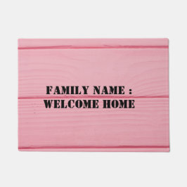 Bienvenido a casa fuera de la alfombra de la puert