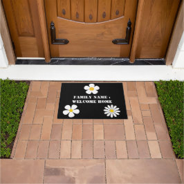 Bienvenido a casa fuera de la alfombra de la puert