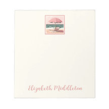 Silla de playa rosa y crema y paraguas