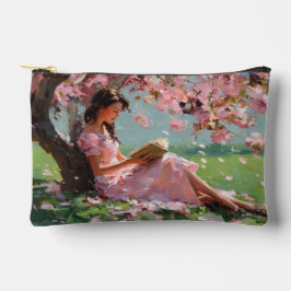 Bolsa de la chica leyendo bajo flor de cerezo