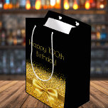 Bolsa De Regalo Mediana 100th birthday black gold bow sparkle<br><div class="desc">Elegant,  classic,  glamorous and feminine style party gift bag for a 100 year old woman.  A gold colored ribbon and bow with faux golden glitter and sparkle,  a bit of bling and luxury for a birthday.  Black background. Golden text: Happy 100th Birthday!</div>