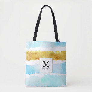 Bolsa de tocador rayada con monograma azul y oro