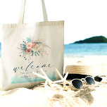 Bolsa de Tote de la boda de destino de playa<br><div class="desc">Haga una declaración elegante con esta bolsa de la boda de la boda de la playa, perfecta para su celebración costera. Con un diseño de acuarela sereno en tonos azul, verde azulado, turquesa y melocotón, junto con delicados acentos florales, ofrece una moda y un ambiente boho. Con la palabra "Bienvenidos"...</div>