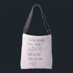 Bolso Cruzado Mother Quote Pink<br><div class="desc">Celebrate Mom with this elegant tote bag featuring the heartfelt quote “To the World You Are a Mother, But to Me You Are the World.” Designed with soft blush pink tones and modern typography, this stylish bag blends sentiment with everyday practicality. Perfect for shopping, daily errands, or thoughtful Mother’s Day...</div>