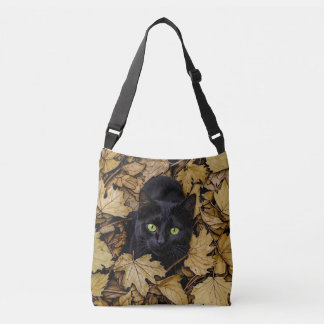 Bolso Cruzado Un gato negro está jugando en las hojas de otoño