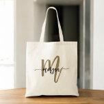 Bolso De Tela Black Gold Modern Script Monograma Nombre<br><div class="desc">Lleve sus productos básicos con estilo con la Bolsa de Tote Bag con el Monograma Negro y Oro Moderno. Con un elegante lienzo negro con un audaz monograma dorado en una letra de escritura moderna, este bolso combina elegancia y funcionalidad. Es lo suficientemente espacioso como para ir de compras, trabajar...</div>