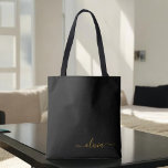 Bolso De Tela Black Name Gold Girly Script Monograma moderno<br><div class="desc">Elegante negro y dorado añade tu propio nombre bolsa de libros monograma. Esta Bolsa de Libros puede ser personalizada para incluir su nombre inicial y de pila y entregarse como regalo para Navidades,  Dulce 16 Cumpleaños,  Ducha de Novias o un Boda.</div>