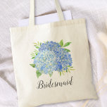 Bolso De Tela Bridesmaid Floral Azul Hidrangea Foliage<br><div class="desc">Esta bolsa de tote de la dama de honor cuenta con una hidrangea azul acuarela y un diseño follaje verde. Puede personalizarlo con un nombre. Visita nuestra tienda o nuestras páginas de colección para ver más productos con este diseño que puedes personalizar para tus necesidades.</div>