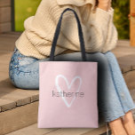 Bolso De Tela Corazón Chic Rosa Personalizado<br><div class="desc">Esta bolsa de mano de color rosa personalizada con tu nombre en una fuente simple sobre un gran corazón blanco. Ideal para ti,  para tus damas de honor,  club de lectura,  regalo de graduación,  regalo de cumpleaños,  regalo para maestros o cualquier ocasión. MÁS colores en nuestra tienda.</div>