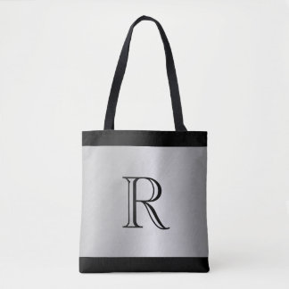 Bolso De Tela Fondo con apariencia metálica plateada con monogra