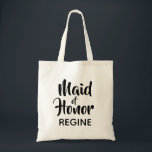 Bolso De Tela La empleada doméstica de honor Monograma a favor<br><div class="desc">Bolsa de tota monogramo tipográfica de tendencia. Moderno y elegante, este diseño personalizado presenta el texto "Maid of Honor" en letras de escritura casual y un campo de texto editable para un nombre en elegante sans serif en negro. Personalice fácilmente este diseño para que coincida con su estilo haciendo clic...</div>