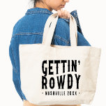 Bolso De Tela Nashville Bachelorette Party Personalizado Get Row<br><div class="desc">¿Buscando el favor perfecto de la soltera? ¡No hay más que mirar a este Nashville metiendo su mochila en ruinas! Este bolso es perfecto para cualquiera que quiera divertirse un poco en su gran día. Cuenta con un divertido diseño de vaquera y es el tamaño perfecto para llevar todo lo...</div>