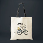 Bolso De Tela Peanuts | Snoopy & Woodstock Bicycle<br><div class="desc">Pedal into style and classic charm with this adorable cream canvas tote bag, featuring Snoopy and Woodstock on a bicycle! This fun tote showcases a delightful line-art illustration of Snoopy, wearing sunglasses, happily riding a vintage-style blue bicycle with Woodstock perched safely behind him. The dashed lines behind the back wheel...</div>
