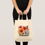 Bolso De Tela Tote bag Fleurs exotiques<br><div class="desc">Un tote bag avec un bouquet explosif de fleurs exotiques aux couleurs chaudes et vibrantes — lys orangés, fleurs corail et blanches sur fond sombre et élégant. Un design tropical et luxuriant qui capture toute la beauté et la générosité de la nature estivale. Parfait pour les amoureux des fleurs, de...</div>