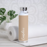 Botella De Agua Boda personalizada de Beige<br><div class="desc">Regale a su boda dama de honor o dama de honor con esta botella de agua insulada al vacío y a la moda que presenta su nombre en blanco y estilizado con un fondo de color beige diseñado para coincidir con su esquema de color boda. Personalice el frasco editando y...</div>