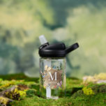Botella De Agua Mariposa Floral Madera Stump Monograma Niños<br><div class="desc">Esta singular botella de agua tiene mariposas,  libélulas y una mariquita sobre un trozo de madera rodeada de una corona floral. Personalízalo para tus necesidades. Puedes encontrar productos coincidentes en mi tienda.</div>